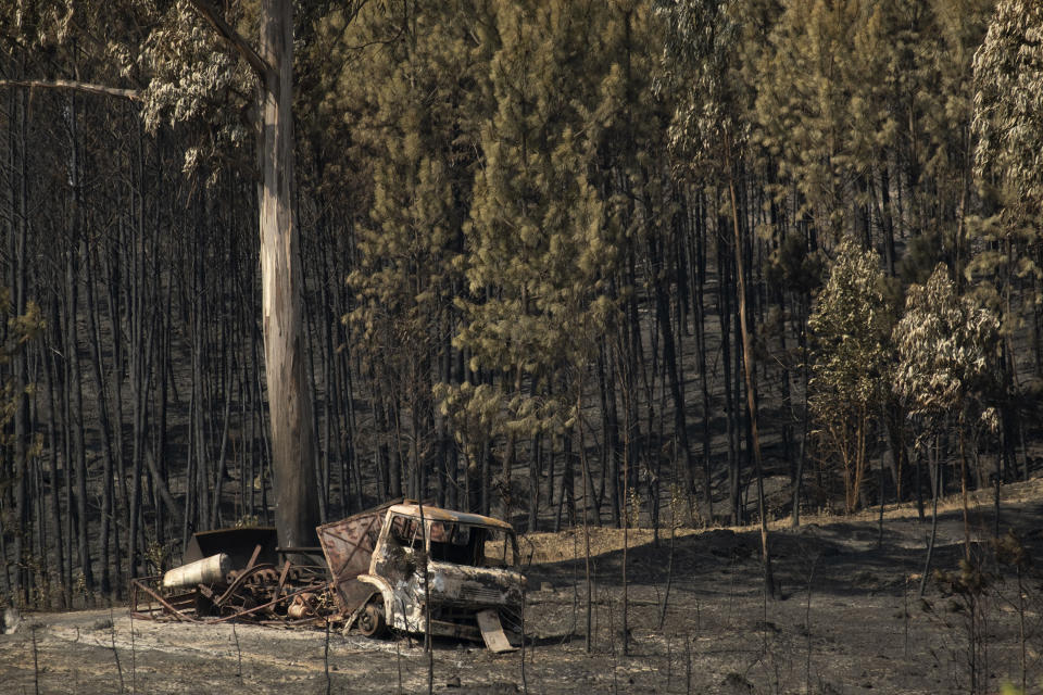 A truck is seen burnt following a fire at the village of Roda, near Macao, in central Portugal on Tuesday, July 23, 2019. Emergency services in Portugal have brought under control a huge wildfire which raged for four days and injured 39 people. Civil Protection Agency commander Luis Belo Costa says around 1,000 firefighters are watching out for smoldering hotspots amid temperatures close to 40 degrees Celsius and gusting winds. (AP Photo/Sergio Azenha)