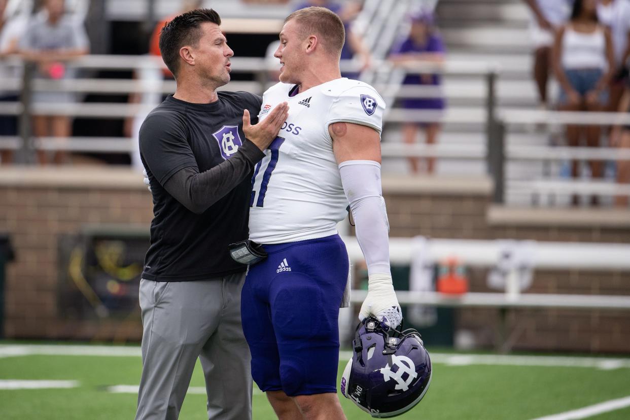 Holy Cross head coach Bob Chesney, left, talks to Jacob Dobbs during warm ups versus Boston College on Saturday September 9, 2023 at Alumni Stadium in Newton.