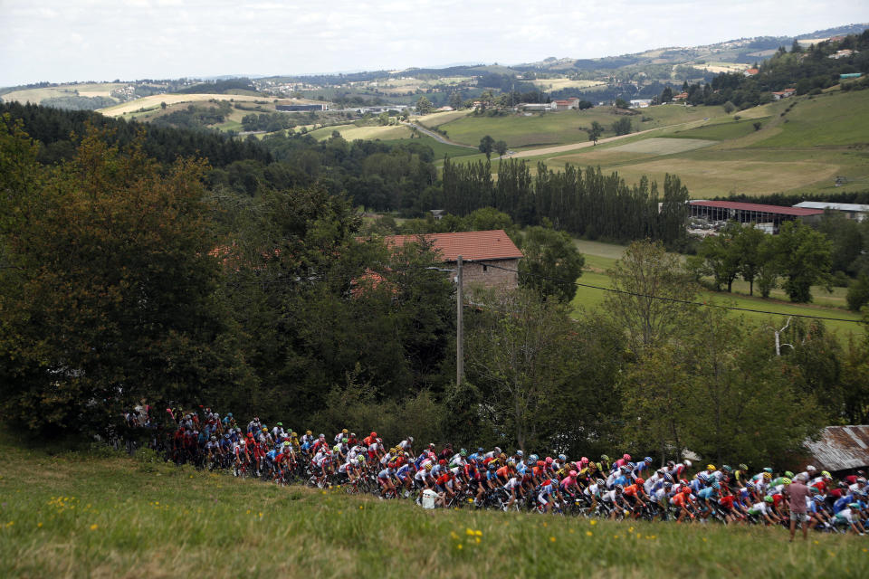 The pack rides during the ninth stage of the Tour de France cycling race over 170.5 kilometers (105.94 miles) with start in Saint Etienne and finish in Brioude, France, Sunday, July 14, 2019. (AP Photo/Thibault Camus)