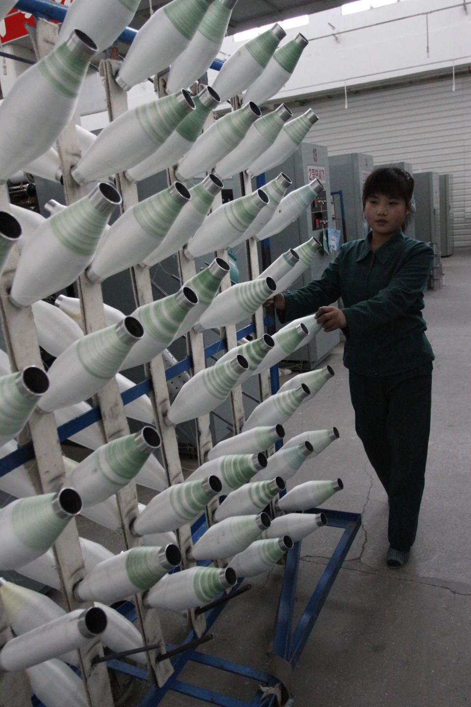 In this Jan. 30, 2012 photo, North Korean women work at a machines inside a factory that produces stockings in Pyongyang, North Korea. (AP Photo/Kim Kwang Hyon)