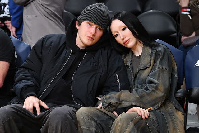 <p>Allen Berezovsky/Getty</p> Noah Cyrus (R) and Pinkus attend a basketball game