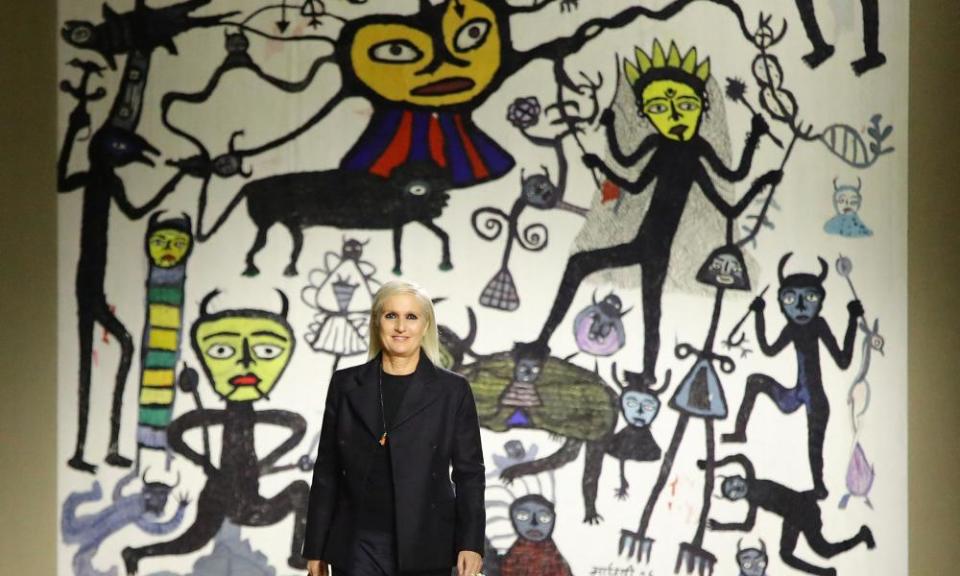 Dior designer Maria Grazia Chiuri on the catwalk in front of a tapestry based on the work of Indian artist Madhvi Parekh.