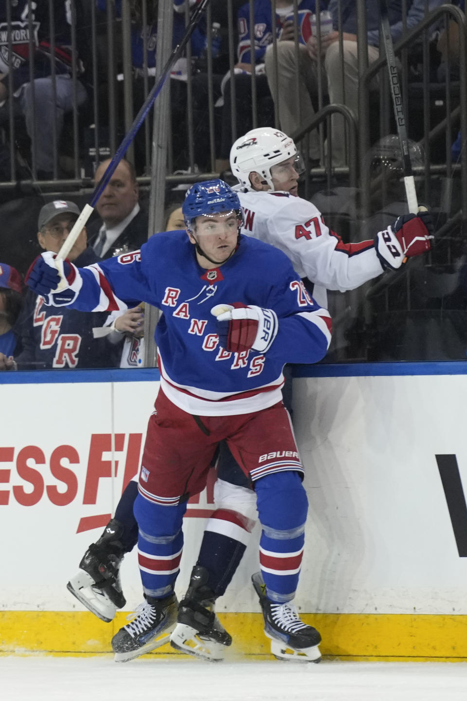 New York Rangers' Jimmy Vesey, front, hits Washington Capitals' Beck Malenstyn (47) during the second period in Game 1 of an NHL hockey Stanley Cup first-round playoff series, Sunday, April 21, 2024, in New York. (AP Photo/Seth Wenig)