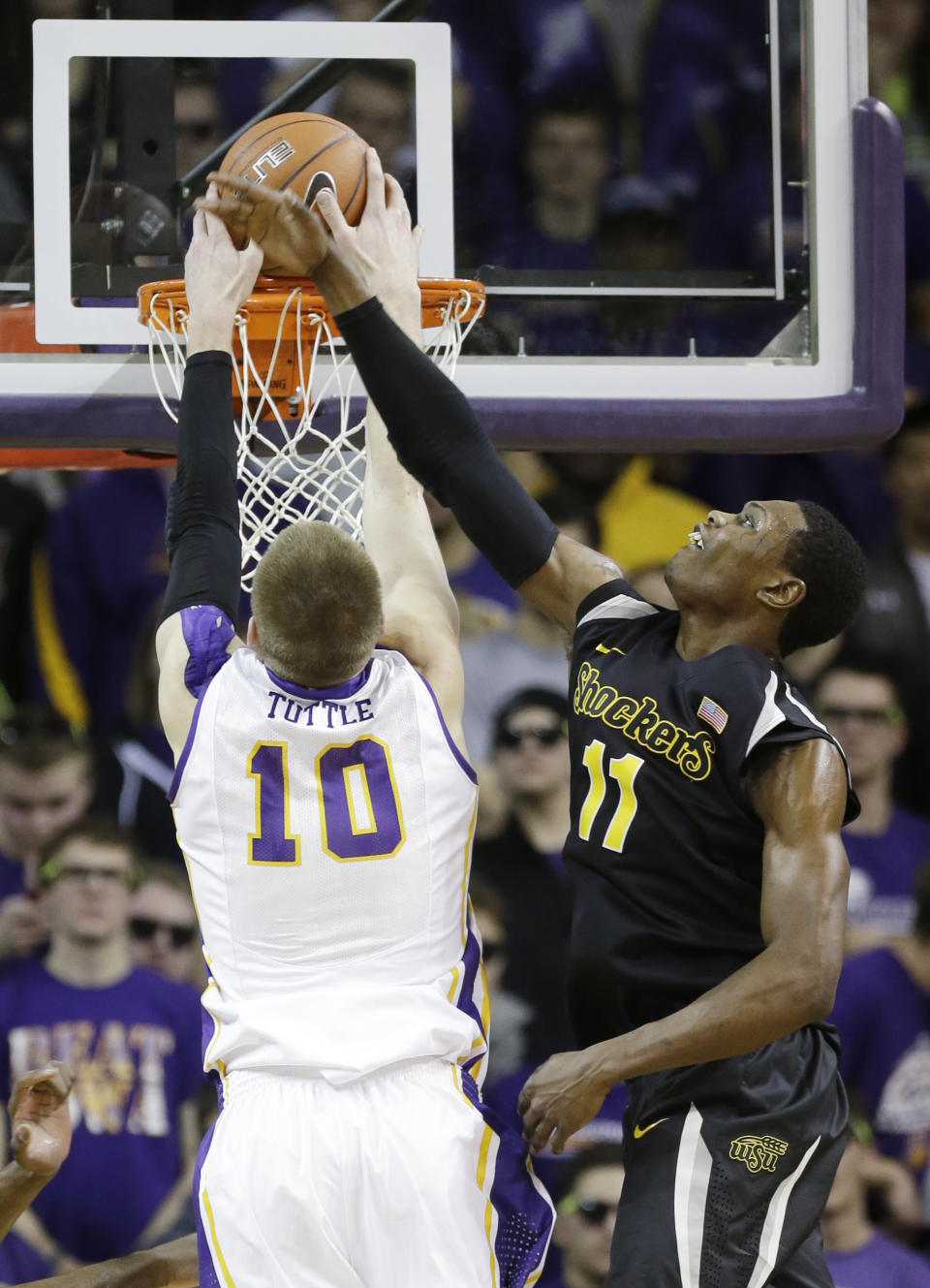 Wichita State forward Cleanthony Early, right, tries to block a shot by Northern Iowa forward Seth Tuttle during the first half of an NCAA college basketball game on Saturday, Feb. 8, 2014, in Cedar Falls, Iowa. (AP Photo/Charlie Neibergall)