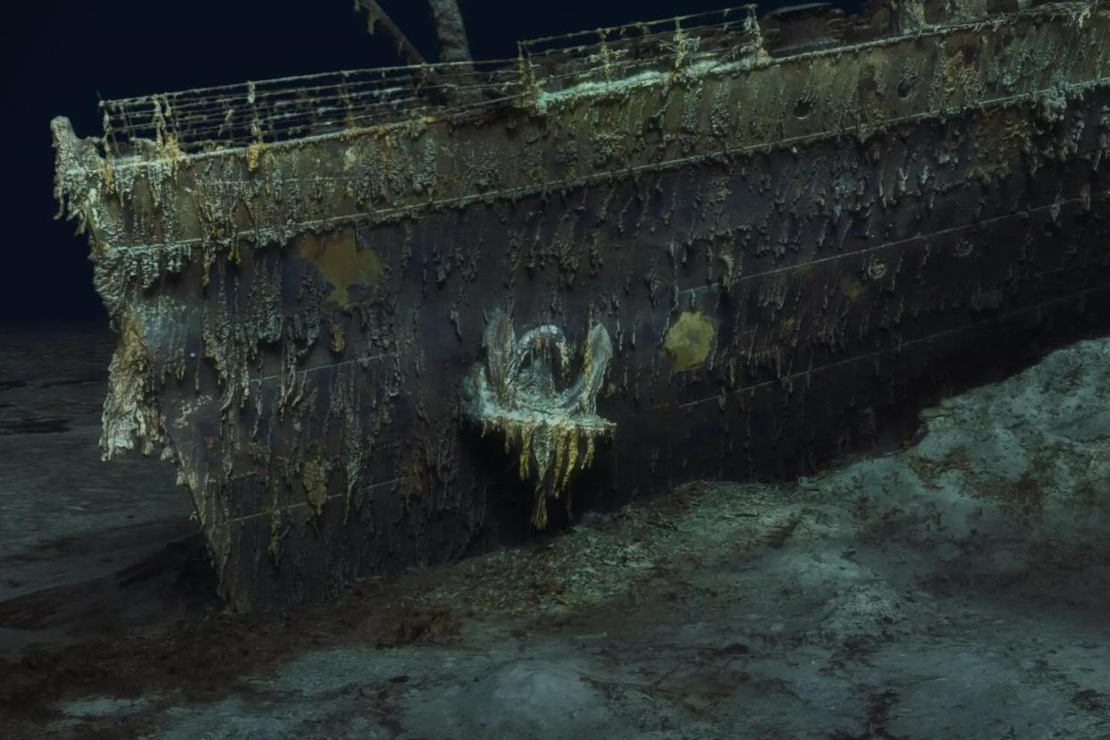  Here we see the sunken bow of the Titanic underwater in extreme detail, with corroding metal and algae growing on the ship.  