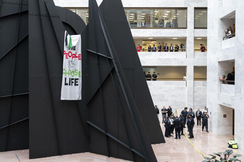 The sculpture by Alexander Calder in the Hart Senate Office Building became part of a protest by a pro-Palestinian activist on Capitol Hill in Washington on Monday, Dec. 11, 2023. Congress is on hold in approving critical new aid for Ukraine and Israel this week. | J. Scott Applewhite, Associated Press