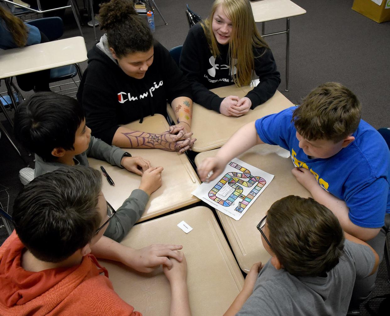 William Peltier, left, Leonidas McDonald, Keyshla Gordon, Andrew Grybas, Cole Miekos and Ethan Ridenour, seventh graders at Jefferson Middle School, play a game they created to test their knowledge about ancient Hebrew history.