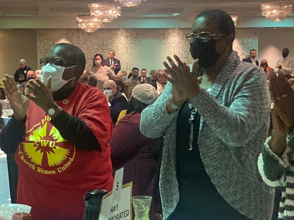 Mazell Taylor, left, and Willa Barger, right, members of Union Baptist Church, applaud after remarks made by the Rev. T. Ray McJunkins, lead pastor at UBC, at the 47th annual Martin Luther King Jr. Memorial Breakfast at the Springfield Wyndham City Centre Monday. McJunkins and the Rev. William DeShone Rosser, pastor of Pleasant Grove Baptist Church, filled in as speakers after Charles Person, an Original Freedom Rider from 1961, canceled as keynote speaker.