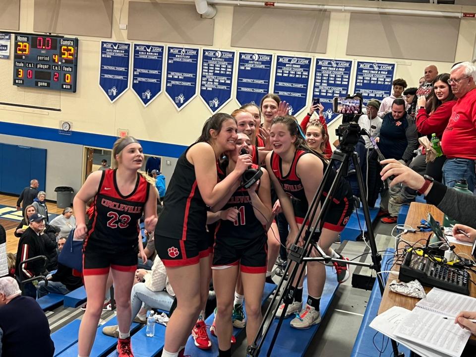 Circleville girls basketball players address injured teammate Addison Edgington after defeating host Washington Court House 52-29 on Jan. 31. It was the Tigers' first game since Edgington, a freshman center, was seriously injured in a car crash five days earlier. Edgington, who is recovering at Nationwide Children's Hospital, watched the game on her mom's phone.