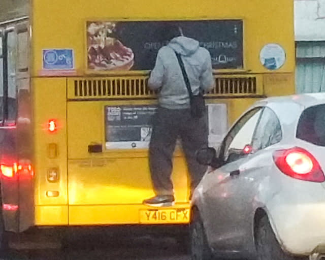 Mandatory Credit: Photo by Paul Edwards/REX/Shutterstock (5556277a) The man clinging to the back of the bus Fare dodger spotted clinging to back of bus, Bournemouth, Britain - 15 Jan 2016 *Full story: http://www.rexfeatures.com/nanolink/rvbp A bus surfer has been spotted clinging to the back of a double-decker bus in rush hour on a busy main road to save paying the ï¿½4 FARE in an "astonishingly stupid" stunt. Electrician Paul Edwards was shocked to see the man clinging to the back of the yellow bus in Bournemouth last Friday. The man, who is wearing a hoody, tracksuit bottoms and woolly hat, is believed to have hitched a lift for at least a quarter of a mile. Paul, 33, from Bournemouth, said: "I couldn't believe it when I saw the man clinging onto the back of the bus. "He must have been hanging on for at least a quarter of a mile. When he got to the traffic lights he got off to see if the lights had changed and the bus driver must have seen him in her mirror. 