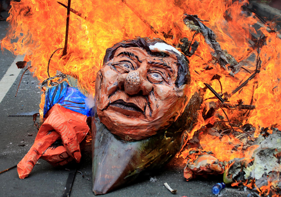 Protesters burn an effigy of Philippine President Rodrigo Duterte to express their outrage while calling for the immediate pullout of U.S. troops in Mindanao province. (Photo: Romeo Ranoco/Reuters)