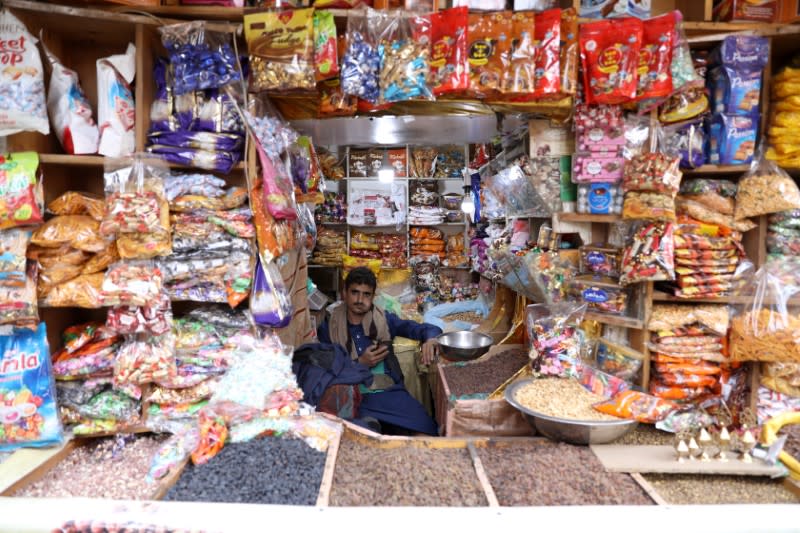 Sweets vendor waits for customers at his shop at the old quarter of Sanaa