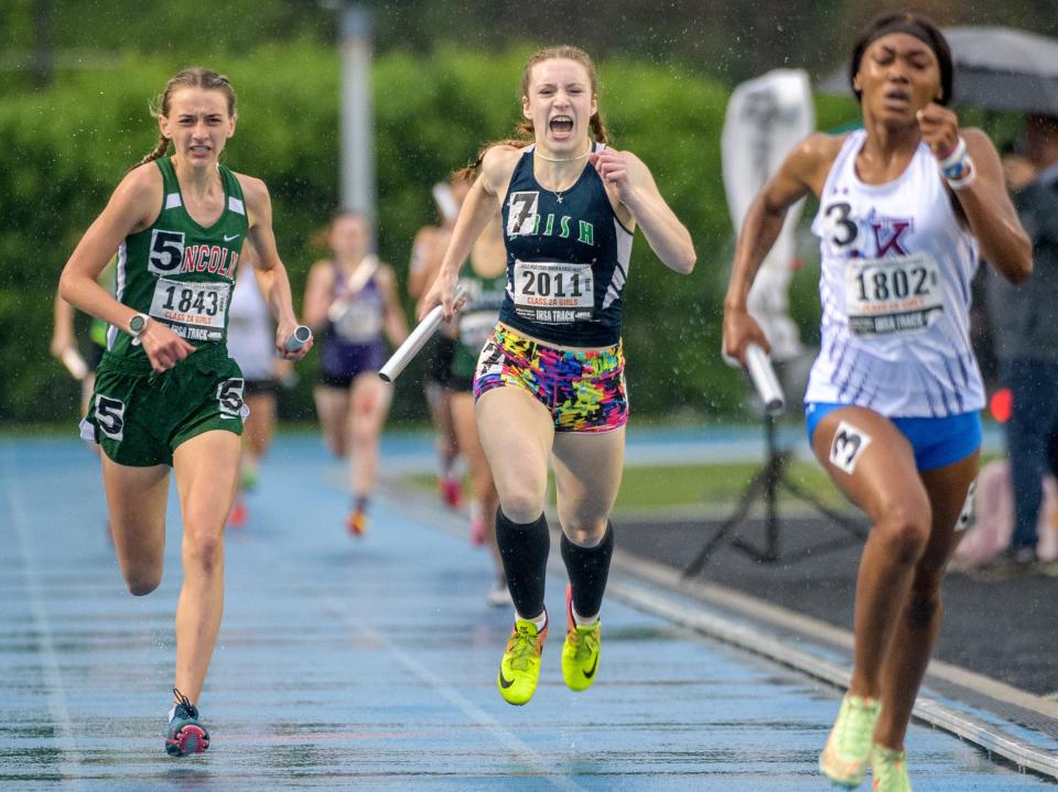 Peoria Notre Dame anchor leg Gillian McDaniel (2011) hangs on for third place while Lincoln's Becca Heitzig, left, takes second and Kankakee's Naomi Bey-Osborne takes the title in the 4X200-meter relay during the Class 2A State Track and Field Championships on Saturday, May 21, 2022 at Eastern Illinois University.