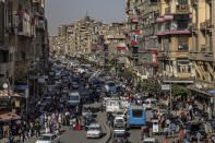 FILE - People crowd a msjor street in Cairo, Egypt, April 14, 2020. Some 1.6 billion people in 94 countries face at least one dimension of the crisis in food, energy and financial systems, according to a report last month by the Global Crisis Response Group of the United Nations Secretary-General. (AP Photo/Nariman El-Mofty, File)