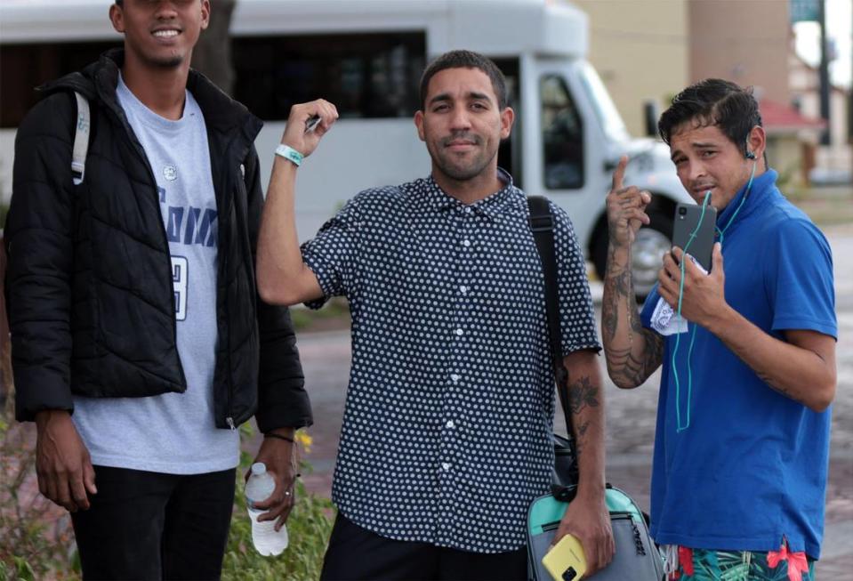 Venezuelan migrants including Pedro Escalona, right, gesture as he and others prepare to depart to the Migrant Resource Center causing several migrants to left behind at the La Quinta hotel. About twenty migrants (mostly men) boarded a charter bus back to the Migrant Resources Center after their flight out of San Antonio, Texas was cancelled on Tuesday, September 20, 2022.