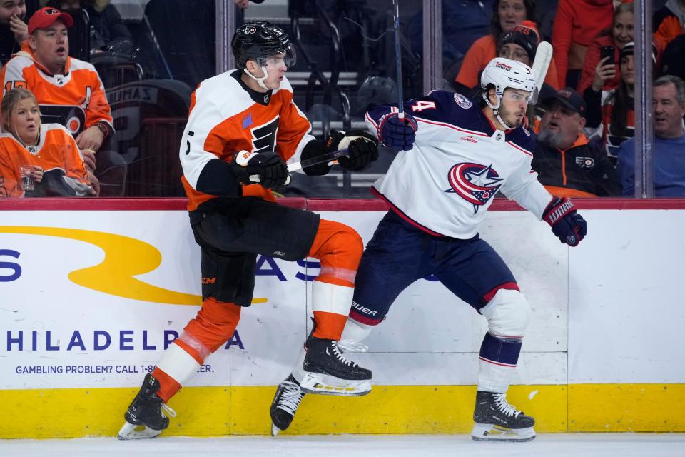 Philadelphia Flyers' Egor Zamula, left, and Columbus Blue Jackets' Cole Sillinger collide during the first period of an NHL hockey game, Thursday, Jan. 4, 2024, in Philadelphia. (AP Photo/Matt Slocum)