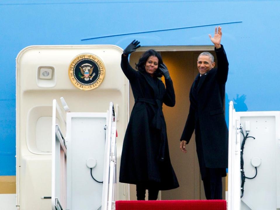 Barack and Michelle Obama wave from Air Force One.