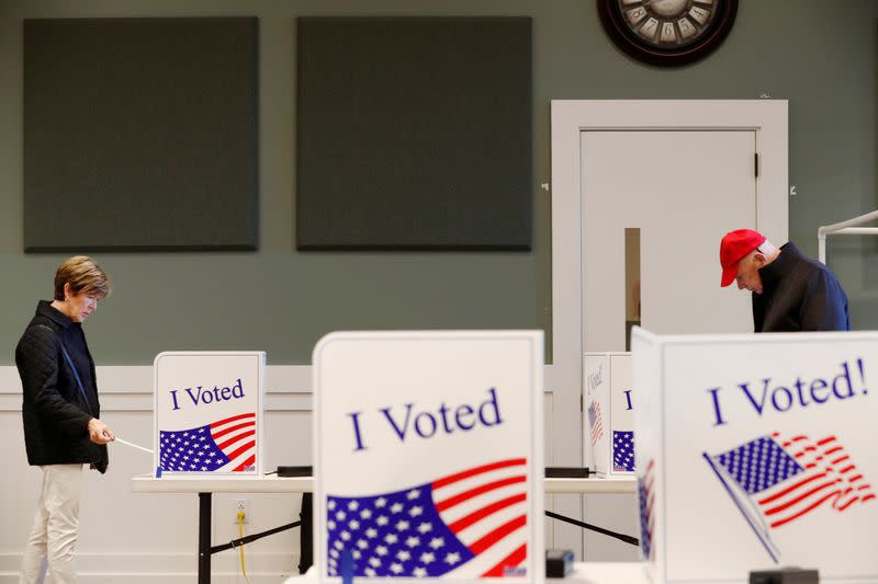 A woman carries her ballot after voting at a polling station for the South Carolina primary in Fort Mill South Carolina