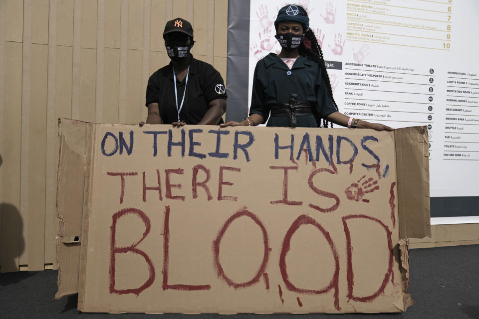 Demonstrators hold a sign during a protest at the COP27 U.N. Climate Summit, Wednesday, Nov. 16, 2022, in Sharm el-Sheikh, Egypt. (AP Photo/Nariman El-Mofty)