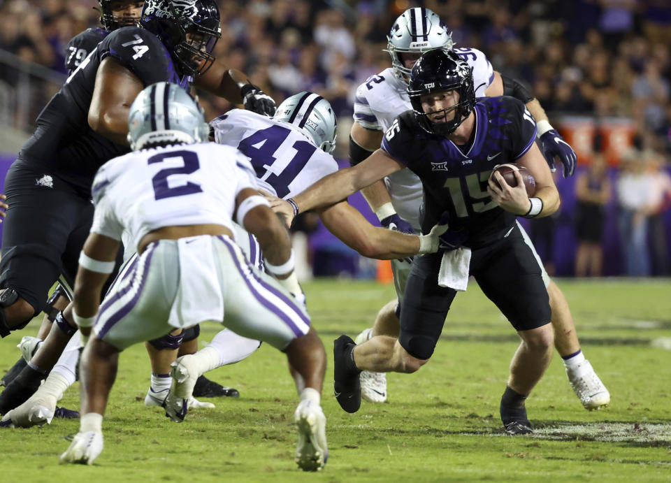 TCU quarterback Max Duggan (15) tries to evade tackle by Kansas State linebacker Austin Moore (41) during the second half of an NCAA football game, Saturday, Oct. 22, 2022, in Fort Worth, Texas. (AP Photo/Richard W. Rodriguez)