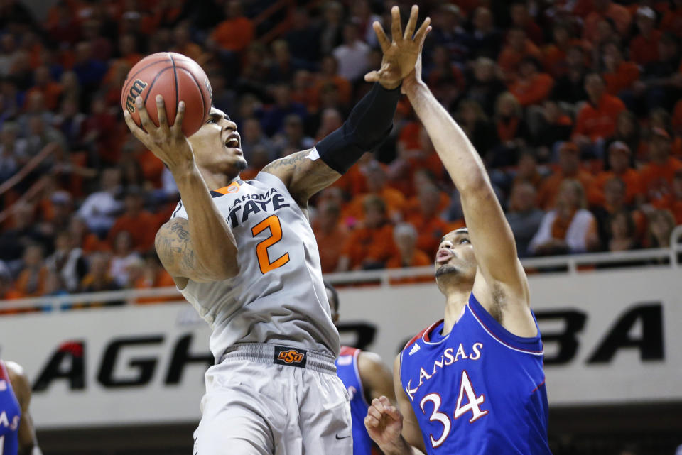 Oklahoma State wing Le'Bryan Nash (2) shoots in front of Kansas forward Perry Ellis (34) during the second half of an NCAA college basketball game in Stillwater, Okla., Saturday, March 1, 2014. Oklahoma State won 72-65. (AP Photo/Sue Ogrocki)