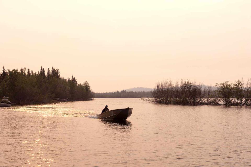 <p>Pat Kane</p> Peter Enzoe on the water in his boat.