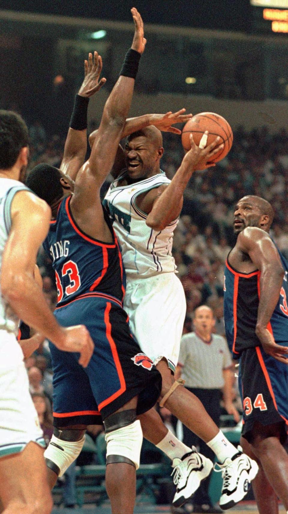 Charlotte Hornets guard Ricky Pierce runs into New York Knicks center Patrick Ewing in 1997. Pierce was drafted No. 18 in the 1982 NBA draft by the Pistons.