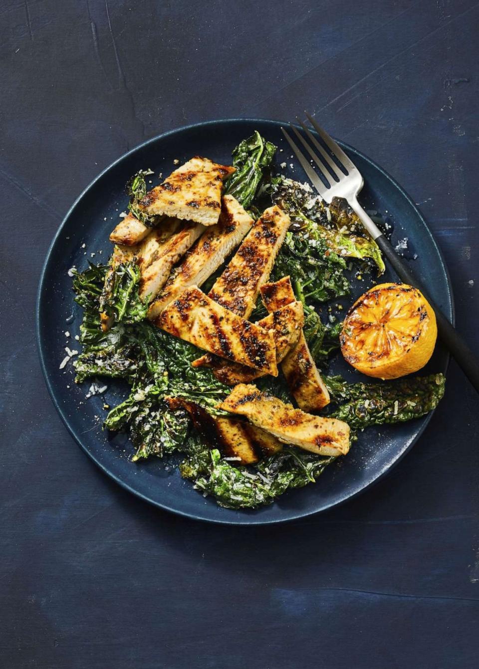 PHOTO: Grilled lemony chicken and kale â€œCaesarâ€. Good Housekeeping Savor Weeknight July/Aug 2022 (Mike Garten)