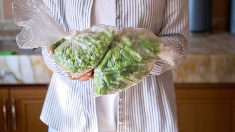 person holding frozen green beans