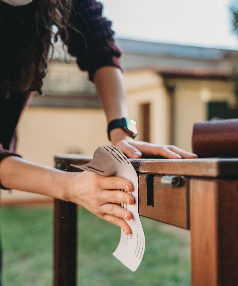 sanding outdoor furniture using sandpaper