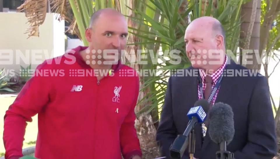 Photo from vision of the red jumper wearing bandit interrupting a press conference.