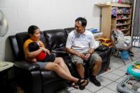 Judith and Jose Ramirez feed their youngest daughter inside their home in Honolulu