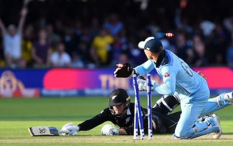 England's Jos Buttler runs out New Zealand's Martin Guptill to win the 2019 Cricket World Cup - Credit: AFP/Getty Images