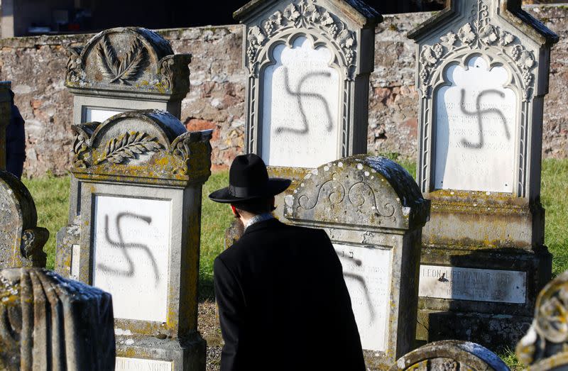 Chief Rabbi Weill looks at graves desecrated with swastikas on the Jewish cemetery in Westhoffen