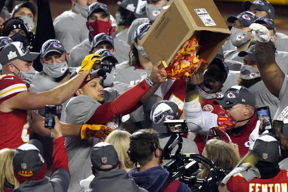 Kansas City Chiefs players dump a box of confetti on head coach Andy Reid after the AFC championship NFL football game against the Buffalo Bills, Sunday, Jan. 24, 2021, in Kansas City, Mo. The Chiefs won 38-24. (AP Photo/Jeff Roberson)