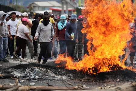 Trucks block main roads during protests after Ecuador's President Lenin Moreno's government ended four-decade-old fuel subsidies, in Calderon, near Quito