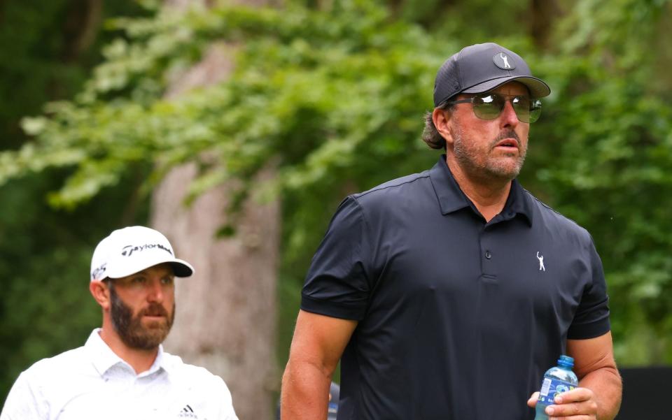 Phil Mickelson and Dustin Johnson on the front nine  - GETTY IMAGES