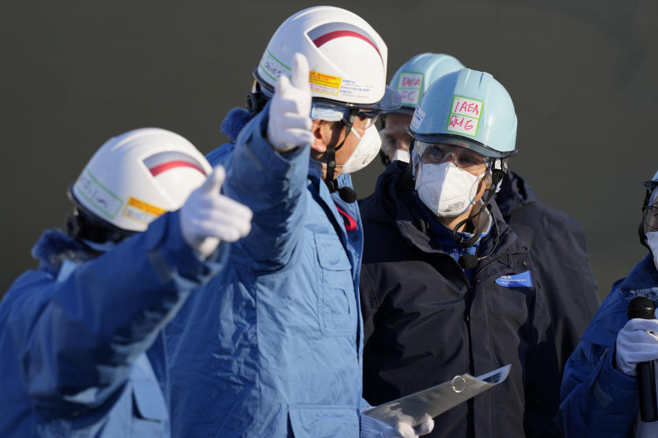 International Atomic Energy Agency Director General Rafael Mariano Grossi, right, is guided by Tokyo Electric Power Co. (TEPCO) President Tomoaki Kobayakawa, left, at a facility for sampling treated and diluted radioactive water at the Fukushima Daiichi nuclear power plant, operated by TEPCO, in Futaba town, northeastern Japan, Wednesday, March 13, 2024. (AP Photo/Eugene Hoshiko, Pool)