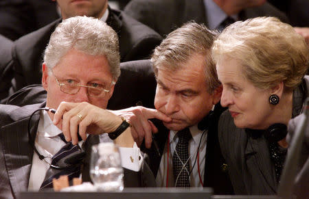 U.S. President Bill Clinton talks with National Security Advisor Sandy Berger and Secretary of State Madeleine Albrigtht moments before delivering stong criticism of Yeltsin's handling of the situation in Chechnya during the opening session of the OSCE summit in Istanbul, Turkey in this November 18, 1999 file photo. REUTERS/Kevin Lamarque/Files