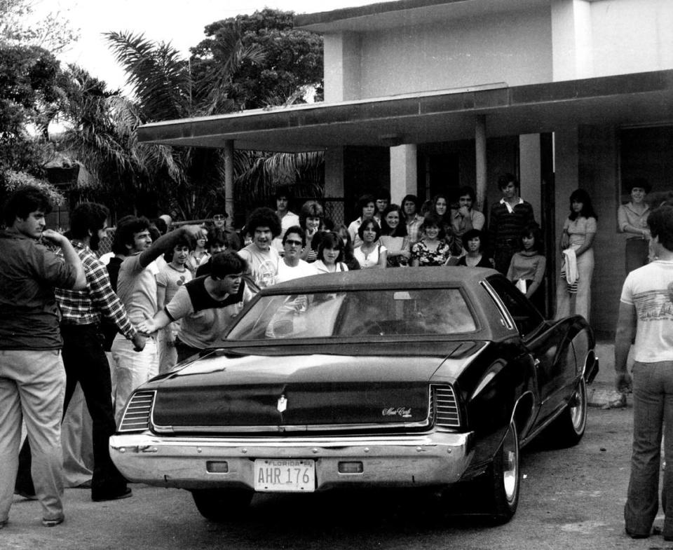 Coral Gables High students gather around a car at school in 1977. Miami Herald File