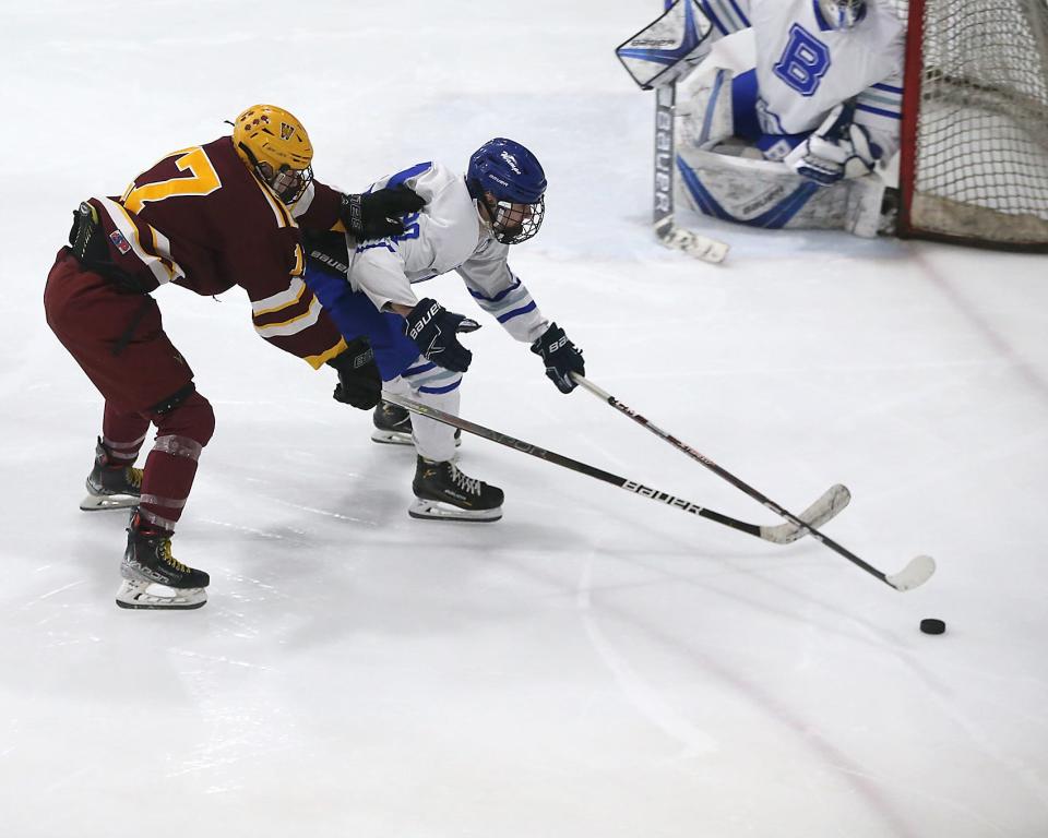 Braintree's Drew Coady looks to fold off Weymouth's Ryan Gaudiano while going after the puck during second period action of their game in the Round of 32 game in the Division 1 state tournament at Zapustas Ice Arena in Randolph on Wednesday, March 1, 2023.