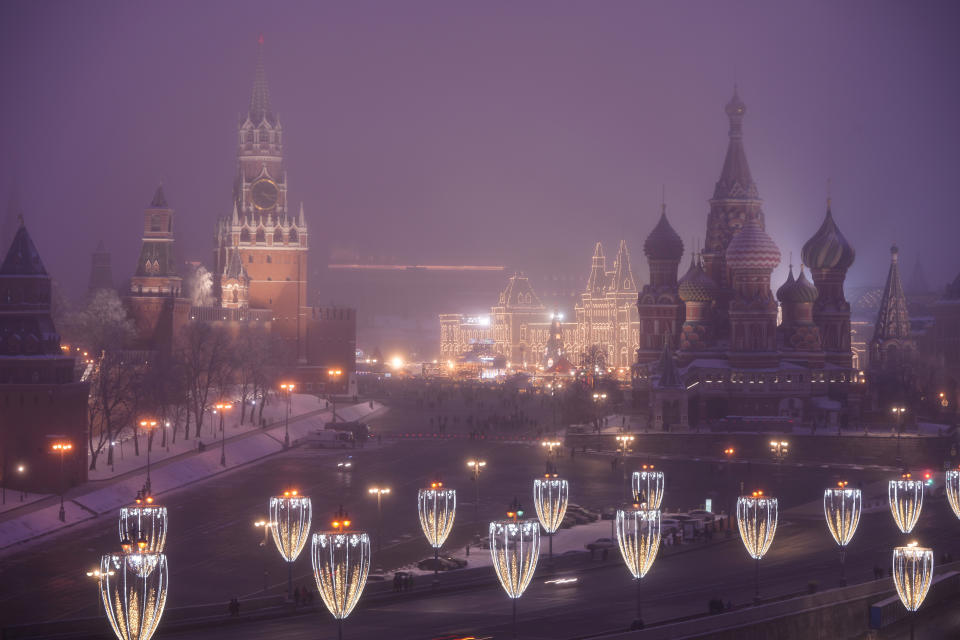 Red Square and the Kremlin are seen through evening fog in Moscow, Russia, Sunday, Dec. 12, 2021. Presidents Joe Biden and Vladimir Putin spoke by phone on Thursday about the Russian troop buildup near Ukraine. It was a new round of leader-to-leader talks that come as the Kremlin has stepped up its calls for security guarantees and test fired hypersonic missiles to underscore its demands. (AP Photo/Alexander Zemlianichenko)