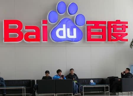 People sit in front of the company logo of Baidu at its headquarters in Beijing December 17, 2014. REUTERS/Kim Kyung-Hoon/File photo