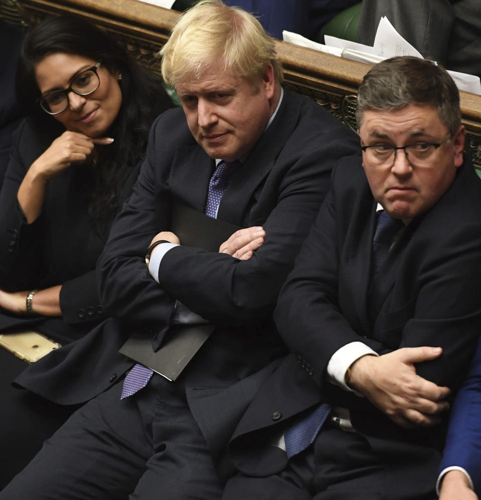 Britain's Prime Minister Boris Johnson, center, sits on the government front bench in the House of Commons in London following the debate for the EU Withdrawal Agreement Bill, Tuesday Oct. 22, 2019. British lawmakers have rejected the government’s fast-track attempt to pass its Brexit bill within days, demanding more time to scrutinize the complex legislation and throwing Prime Minister Boris Johnson’s exit timetable into chaos. (Jessica Taylor, UK Parliament via AP)