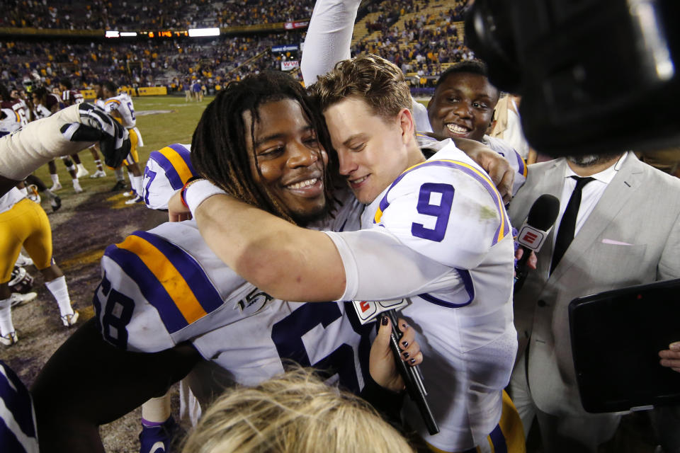 LSU quarterback Joe Burrow (9) hugs guard Damien Lewis after the team's NCAA college football game against Texas A&M in Baton Rouge, La., Saturday, Nov. 30, 2019. LSU won 50-7. (AP Photo/Gerald Herbert)