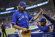 Toronto Blue Jays starting pitcher Kevin Gausman heads to the dugout after the top of the first inning of a baseball game against the Boston Red Sox in Toronto, Sunday, Oct. 2, 2022. (Cole Burston/The Canadian Press via AP)