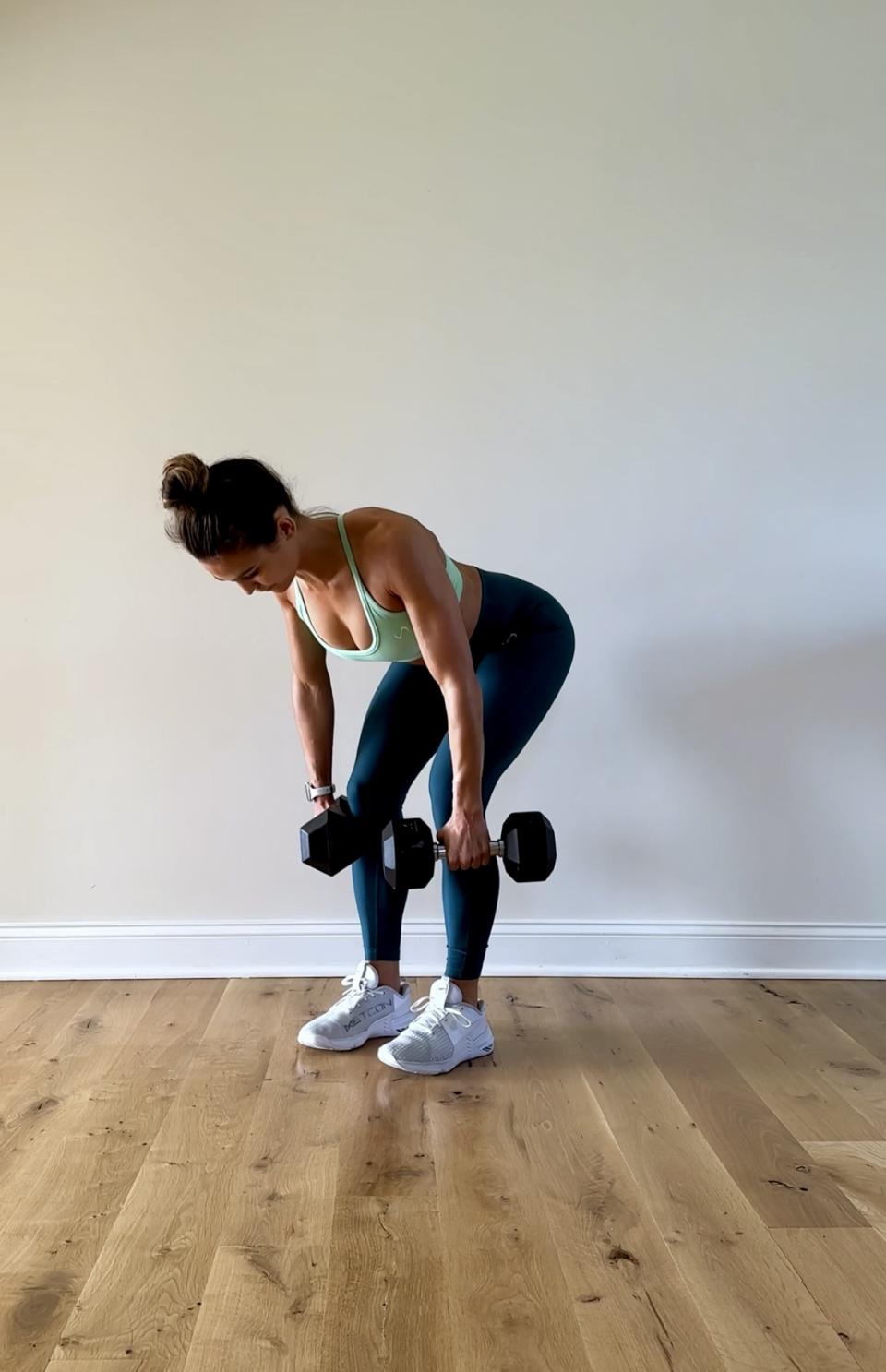 Trainer Melissa Kendter demonstrating a Romanian deadlift