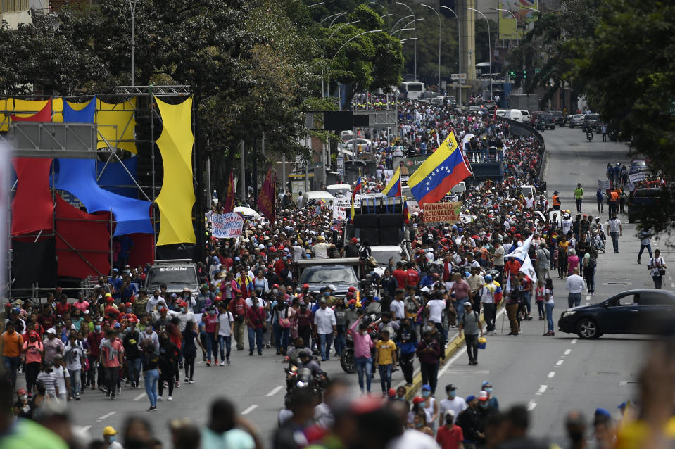 Government supporters march marking Youth Day, in Caracas, Venezuela, Saturday, Feb. 12, 2022. The annual holiday commemorates the young people who accompanied heroes in the battle for Venezuela's independence. (AP Photo/Matias Delacroix)