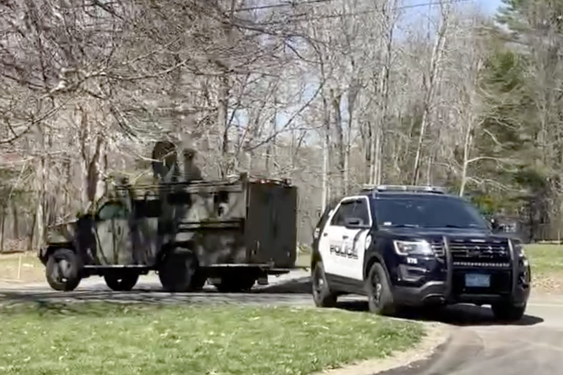 In this image taken from video, police block a road in North Dighton, Mass., Thursday, April 13, 2023. The FBI wants to question a 21-year-old member of the Massachusetts Air National Guard in connection with the disclosure of highly classified military documents on the Ukraine war, two people familiar with the investigation said. (AP Photo/Michelle R. Smith)