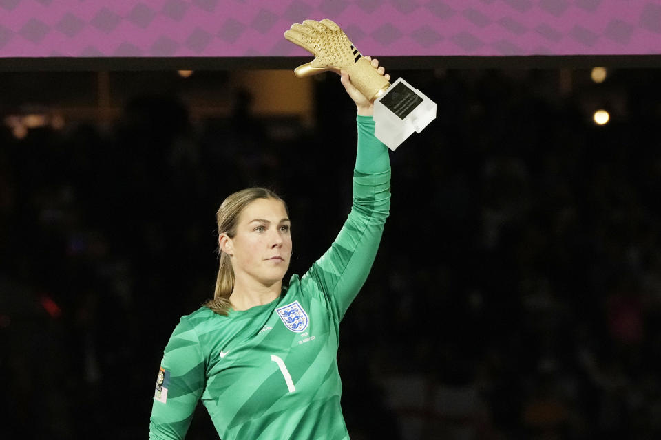 England's goalkeeper Mary Earps holds the Golden Glove trophy after the final of Women's World Cup soccer between Spain and England at Stadium Australia in Sydney, Australia, Sunday, Aug. 20, 2023. (AP Photo/Rick Rycroft)